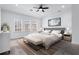 This bedroom offers large windows for natural light and a neutral color palette for relaxation at 145 Rose Garden Ln, Alpharetta, GA 30009