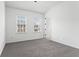 A bright bedroom with neutral carpet, white walls, and two windows offering natural light at 145 Rose Garden Ln, Alpharetta, GA 30009