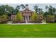 Lush lawn leading to a classically designed community building with a prominent clock tower at 145 Rose Garden Ln, Alpharetta, GA 30009