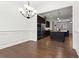 Dining room with hardwood floors and wainscoting, leading into the kitchen at 145 Rose Garden Ln, Alpharetta, GA 30009