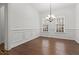 Dining room with hardwood floors, chandelier, and wainscoting at 145 Rose Garden Ln, Alpharetta, GA 30009