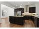 Modern kitchen with dark wood cabinetry, granite countertops, and stainless steel appliances at 145 Rose Garden Ln, Alpharetta, GA 30009