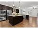 Open kitchen featuring dark wood cabinets, granite counters, and stainless steel appliances at 145 Rose Garden Ln, Alpharetta, GA 30009