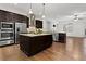 Modern kitchen with granite countertops, stainless steel appliances and dark wood cabinets at 145 Rose Garden Ln, Alpharetta, GA 30009