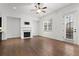 Well-lit living room featuring hardwood floors, a fireplace, and access to the outdoors at 145 Rose Garden Ln, Alpharetta, GA 30009