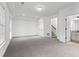 A bright living room with neutral carpet, white walls, and windows offering natural light at 145 Rose Garden Ln, Alpharetta, GA 30009