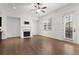 Bright living room with fireplace, large windows, and hardwood floors at 145 Rose Garden Ln, Alpharetta, GA 30009