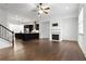 Bright living area with fireplace and a view of the open-concept kitchen with stainless appliances at 145 Rose Garden Ln, Alpharetta, GA 30009