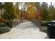 Charming walking bridge surrounded by colorful trees and foliage, perfect for enjoying the natural setting at 145 Rose Garden Ln, Alpharetta, GA 30009