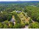 Expansive estate surrounded by lush trees and featuring a long driveway at 2595 Ross Rd, Snellville, GA 30039