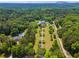 Expansive estate surrounded by lush trees and featuring a long driveway at 2595 Ross Rd, Snellville, GA 30039