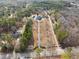 Aerial view of grand estate featuring a long private driveway, large yard, pool, and mature trees at 2595 Ross Rd, Snellville, GA 30039