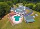 Backyard oasis with a T-shaped pool, patio, and well-maintained landscaping at 2595 Ross Rd, Snellville, GA 30039