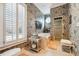 A bathroom featuring floral wallpaper, a soaking tub, a shower, and a round accent window at 2595 Ross Rd, Snellville, GA 30039