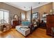 Bedroom with hardwood floors, natural wallpaper, wooden furniture, and a four-poster bed at 2595 Ross Rd, Snellville, GA 30039