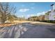 Long driveway leading to a stately home set on a sprawling lawn with mature trees at 2595 Ross Rd, Snellville, GA 30039