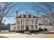 Grand home showcasing stately columns, a second-story balcony, and manicured landscaping at 2595 Ross Rd, Snellville, GA 30039