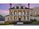 Elegant colonial home featuring stately white columns and classic architectural details at 2595 Ross Rd, Snellville, GA 30039