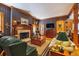 A cozy living room featuring plaid wallpaper, a fireplace, wood trim, and vintage decor elements at 2595 Ross Rd, Snellville, GA 30039