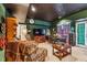 Cozy living room featuring dark green walls, a black ceiling, comfortable seating, and a dining area at 2595 Ross Rd, Snellville, GA 30039