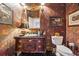 A colorful powder room with patterned wallpaper, a pedestal sink, and vintage-inspired decor at 2595 Ross Rd, Snellville, GA 30039