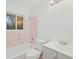 Bright bathroom with tub, white toilet, and vanity featuring gray cabinets at 6605 Black Bend Ct, Riverdale, GA 30274