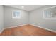 Spacious bedroom featuring hardwood floors and two large windows at 6605 Black Bend Ct, Riverdale, GA 30274