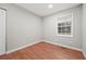 This bedroom features hardwood floors, a window for natural light, and neutral wall paint at 6605 Black Bend Ct, Riverdale, GA 30274