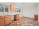 Sunlit kitchen featuring wooden cabinets, granite countertops, and stylish tiled floors at 6605 Black Bend Ct, Riverdale, GA 30274