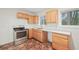 Kitchen featuring wooden cabinets, granite countertops, and stainless steel appliances at 6605 Black Bend Ct, Riverdale, GA 30274