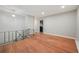 Bright living room featuring hardwood floors and a staircase with iron railing at 6605 Black Bend Ct, Riverdale, GA 30274