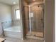 Bright bathroom featuring a glass enclosed shower and a soaking tub at 738 Basswood Ave, Mcdonough, GA 30252