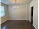 Bright dining room featuring hardwood floors, neutral walls and contemporary lighting at 738 Basswood Ave, Mcdonough, GA 30252