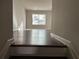 View from the top of the stairs looking out onto the hallway with wood-look flooring at 738 Basswood Ave, Mcdonough, GA 30252