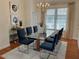 Elegant dining room with glass table, seating for eight, modern chandelier, and bright window at 3101 Howell Mill Nw Rd # 327, Atlanta, GA 30327