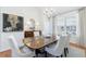 Elegant dining room features hardwood floors, a chandelier, and a large window with ample natural light at 3101 Howell Mill Nw Rd # 327, Atlanta, GA 30327