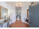 Inviting foyer featuring a stylish chandelier, console table with decor, and bench seating at 3101 Howell Mill Nw Rd # 327, Atlanta, GA 30327