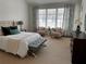 Comfortable main bedroom with large window, seating area, plush bedding, and decorative accents at 3101 Howell Mill Nw Rd # 327, Atlanta, GA 30327