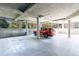 A red car is parked in a clean, well-lit garage with concrete columns and secure fencing at 3101 Howell Mill Nw Rd # 327, Atlanta, GA 30327