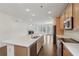 Open-concept kitchen featuring stainless steel appliances and a view of the fireplace at 615 Grassmeade Ln, Woodstock, GA 30188