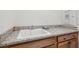 Laundry room featuring white utility sink with granite countertop and storage at 615 Grassmeade Ln, Woodstock, GA 30188