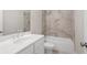 Bathroom featuring a single sink vanity, tiled walls, and a bathtub with shower at 1322 Parc Bench Rd, Atlanta, GA 30316