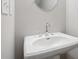 Elegant bathroom with a white pedestal sink, modern faucet, and decorative mirror at 1322 Parc Bench Rd, Atlanta, GA 30316