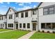 Charming new construction townhomes with white brick and siding, complemented by lush green lawns and professional landscaping at 1322 Parc Bench Rd, Atlanta, GA 30316