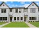 Charming new construction townhomes with white brick and siding, complemented by lush green lawns and professional landscaping at 1322 Parc Bench Rd, Atlanta, GA 30316
