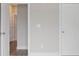 Hallway featuring white doors, neutral walls, and wood flooring at 1322 Parc Bench Rd, Atlanta, GA 30316