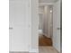 Hallway featuring white doors, neutral walls, and mixed carpet and wood flooring at 1322 Parc Bench Rd, Atlanta, GA 30316