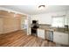 Modern kitchen featuring white cabinets and stainless steel appliances open to dining at 1616 W Kellogg Cir, Douglasville, GA 30134