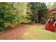 Home backyard featuring a wooded area and deck at 4651 Oakleigh Manor Dr, Powder Springs, GA 30127