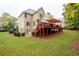 Exterior view of a home with a spacious backyard, featuring a two-story deck and lush landscaping at 4651 Oakleigh Manor Dr, Powder Springs, GA 30127